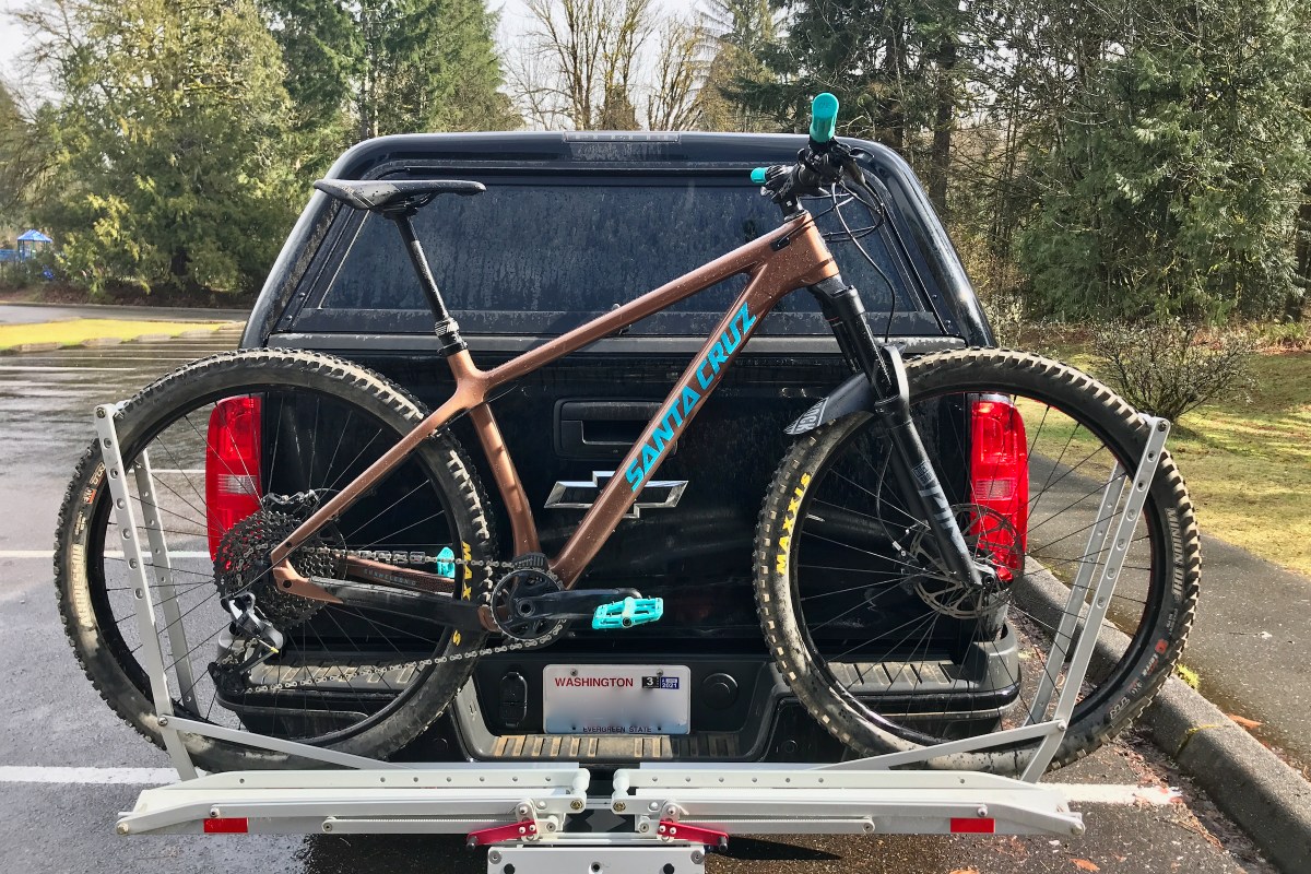 Brown Santa Cruz Chameleon mountain bike loaded on OneUp bike rack in parking lot.