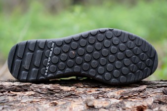 Black Five Ten Trailcross LT mountain bike shoe sole sitting on a log.