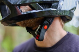 D-ring buckle on black and white Smith Mainline full-face mountain bike helmet.