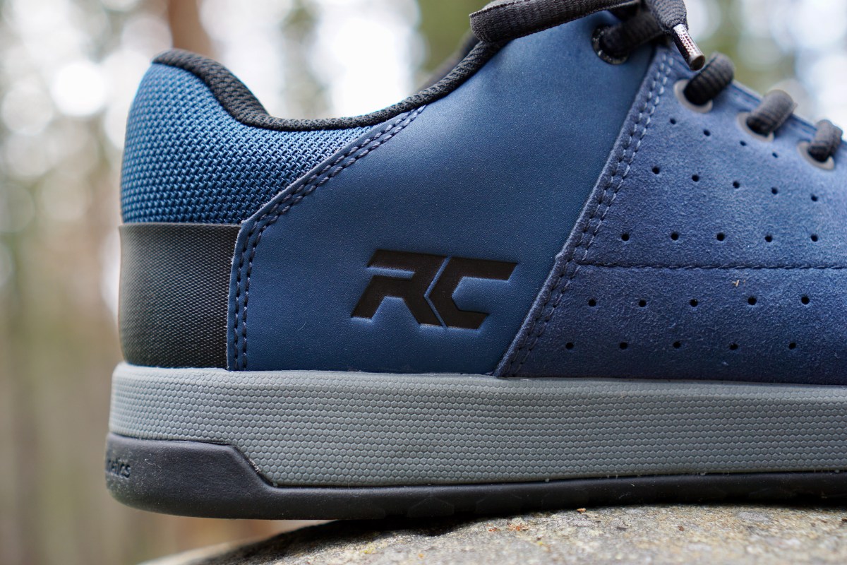 Close up of Ride Concepts logo on blue Ride Concepts Livewire flat pedal mountain bike shoe.