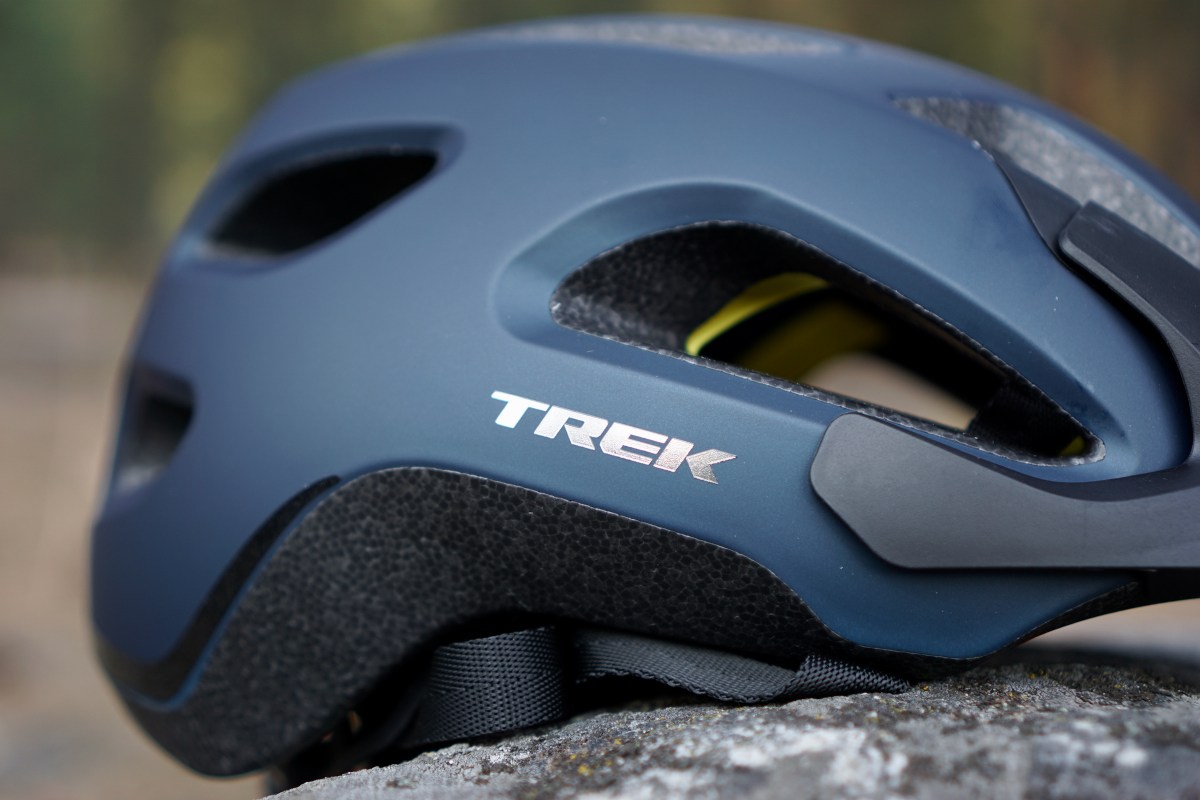 CLose up of reflective Trek mountain bike helmet logo.